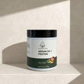 Jar of Nourish Vida Argan Oil + Protein Hair Milk on a beige background