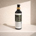 Bottle with a label on a textured beige surface